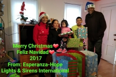 Two of our staff, a mother carrying her daughter, and her son; a Merry Christmas greeting from Esperanza-Hope