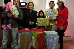 Our staff with a family of five, holding gifts (close-up)