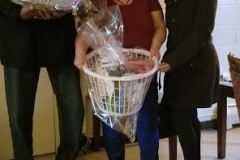 Cropped photo of three people with a basket of grocery and bag of turkey