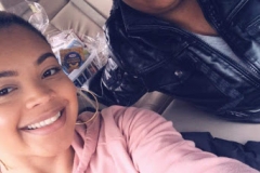 A woman taking a selfie with another person, cropped