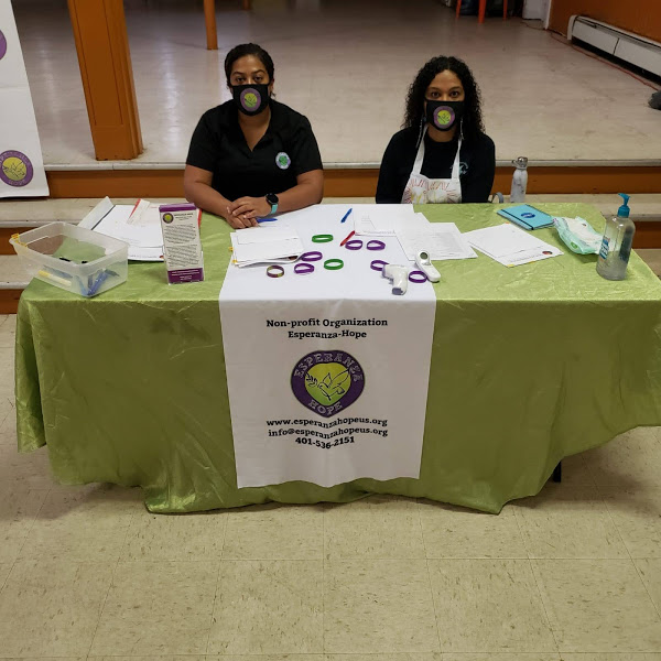 Two women wearing masks at the registration table