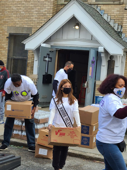 Ms. Rhode Island and our other staff carrying a box