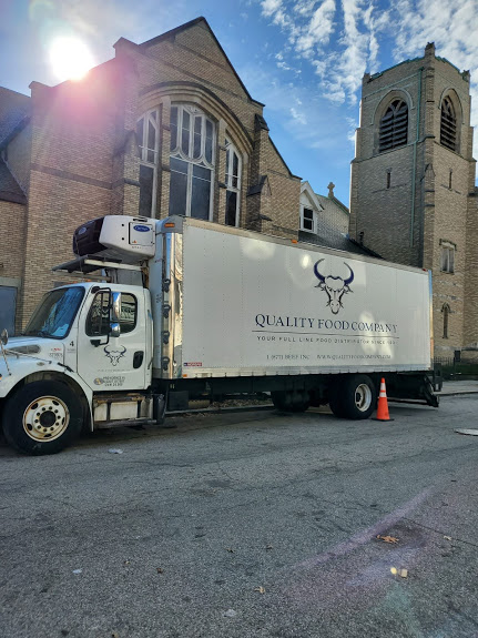 A Quality Food Company truck in front of the church