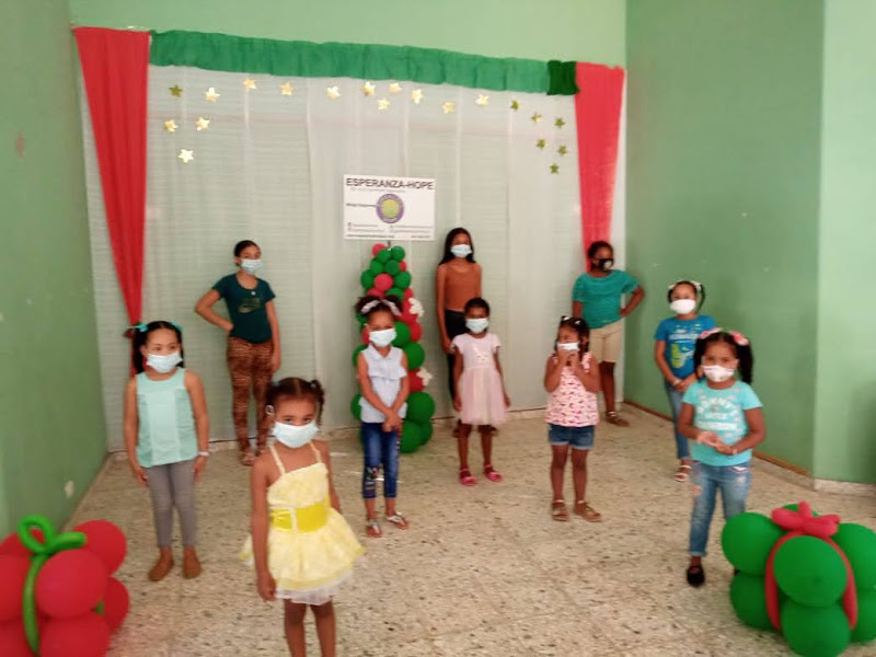 Another group of young girls wearing masks, standing and posing