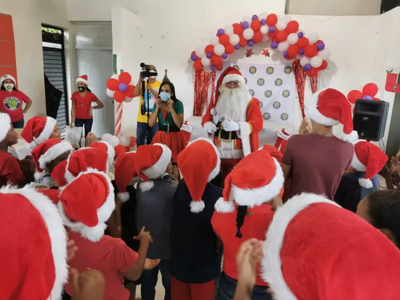 Children standing up and facing Santa Claus