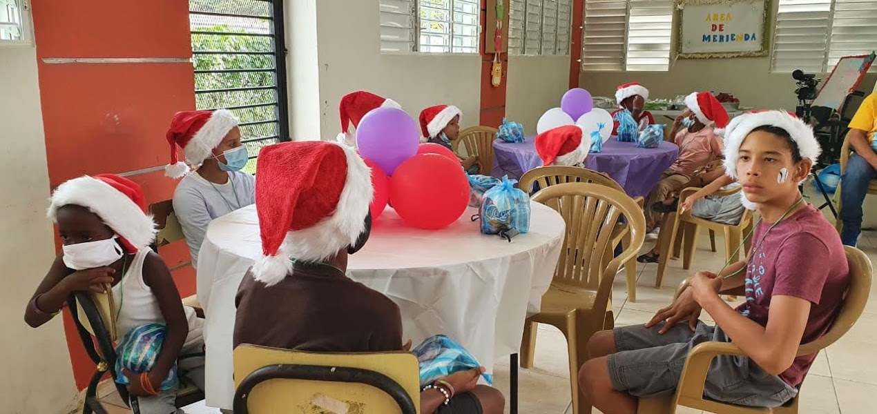 A table of children wearing Santa hats
