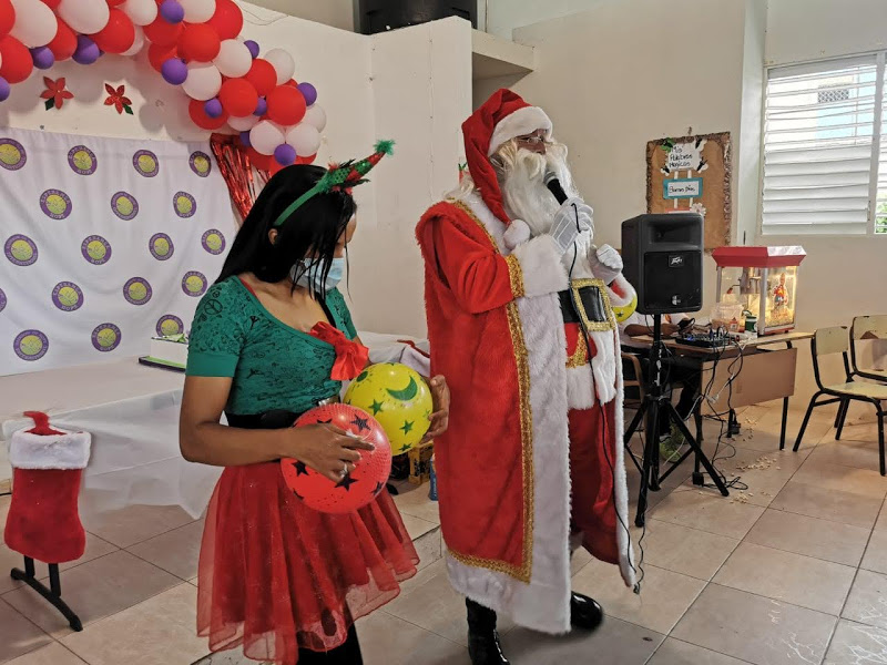 Santa Claus and a female elf hosting the party