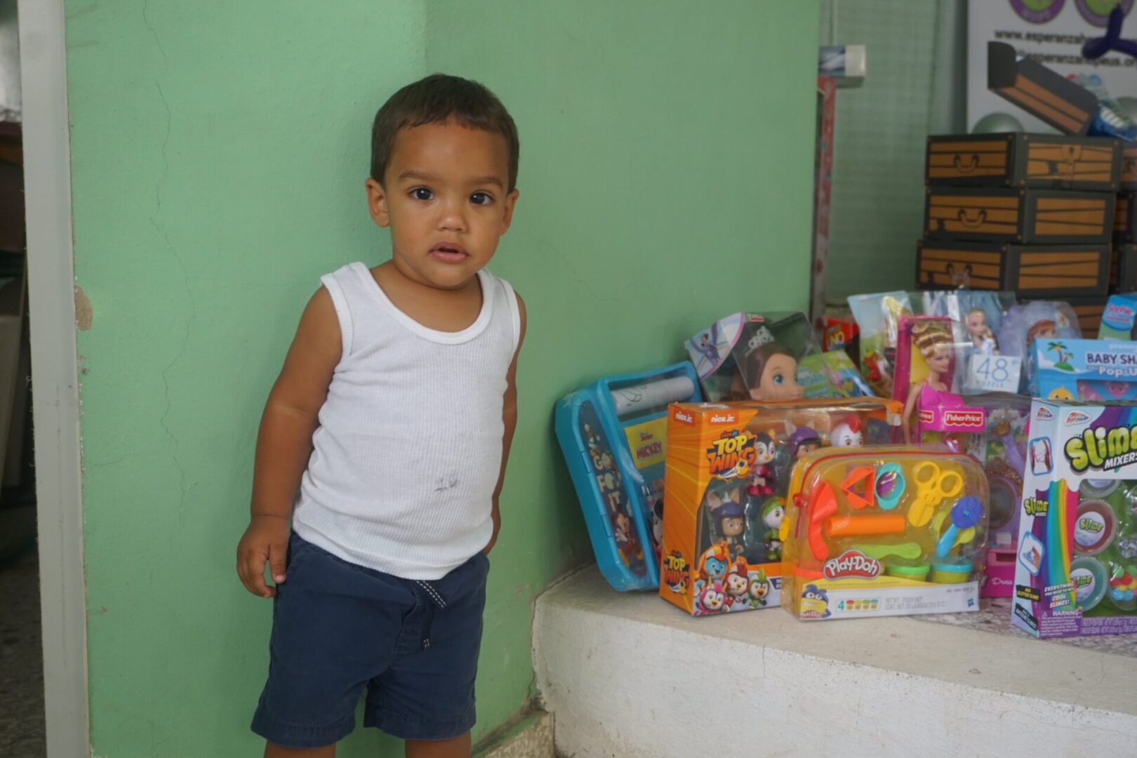 A little boy standing near the toys
