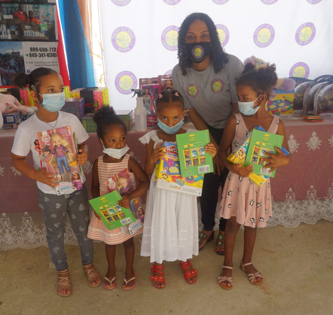 Four young girls wearing masks and holding books and toys, batch 4