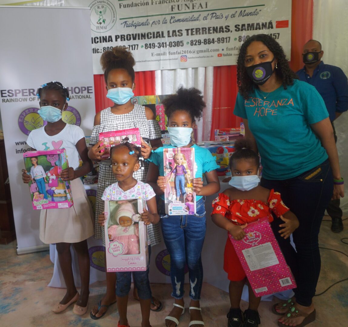 Our staff and five girls, each child holding a boxed toy