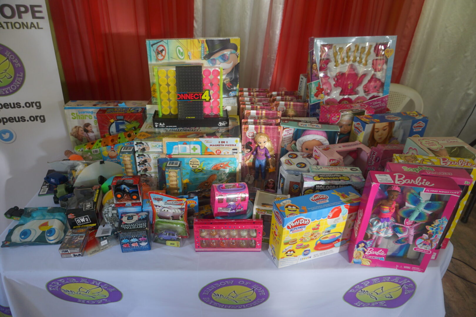 A table with Esperanza-Hope logos full of toys (different angle)