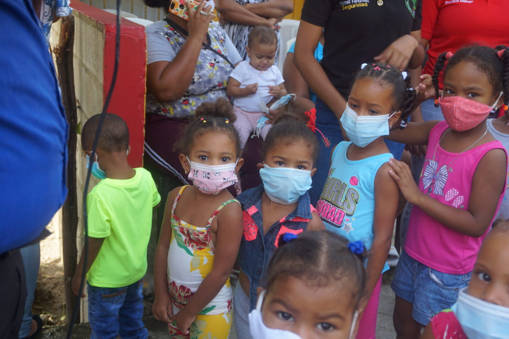 Young girls wearing masks and forming a line
