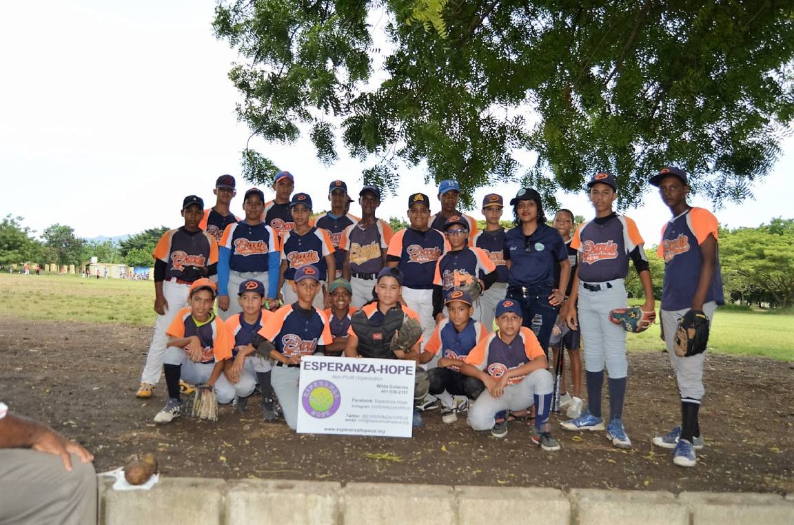 A children’s baseball team wearing a navy blue and orange uniform